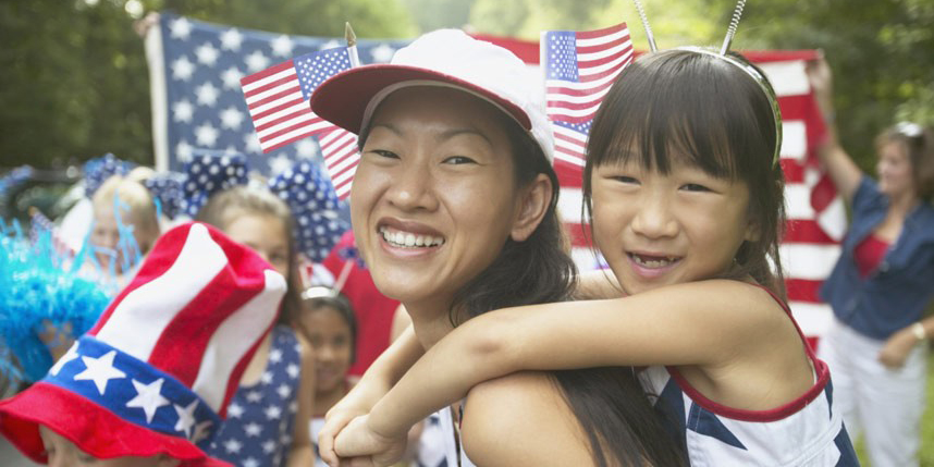Asian mother and daughter in Fourth of July parade