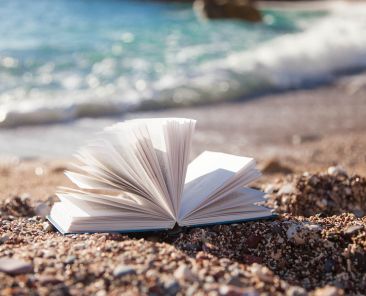 Open book on sea beach