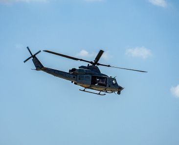 Army helicopter hovering on a blue sky background. Helicopter on a routine surveillance mission in San Diego, California, USA. September 13th, 2019