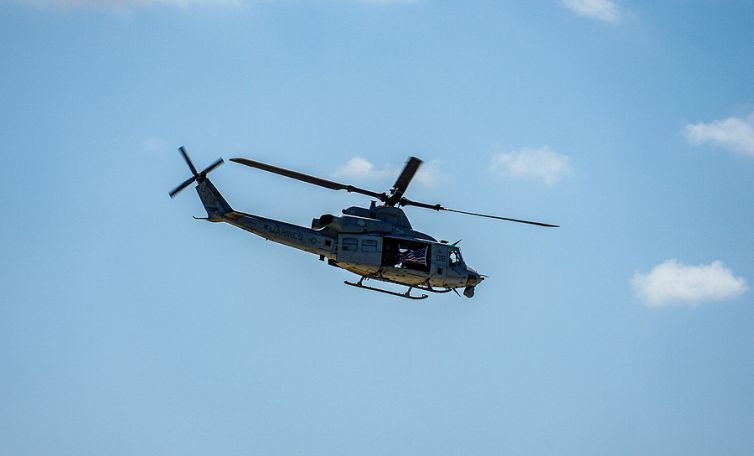 Army Helicopter Hovering On A Blue Sky Background. Helicopter On