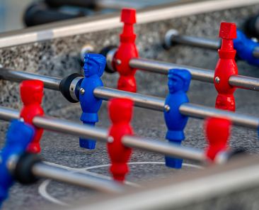 outdoor football table to play football with red and blue players, close-up