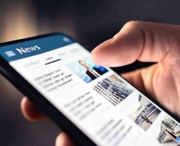 News feed in phone. Watching and reading latest online articles and headlines from smartphone newspaper mobile app. Daily digital information portal and publication. Media and press on internet.