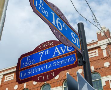 TAMPA, FL, USA - JAN. 26, 2019: Ybor road sign at E 7th Avenue at N 16th Street in Ybor City Historic District in Tampa, Florida FL, USA.