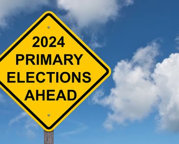 2024 Primary Elections Ahead Caution Sign - Blue Sky Background