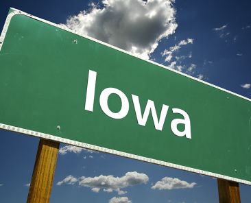 Iowa Road Sign with dramatic clouds and sky.