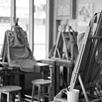 Interior of the creative art workshop with wooden easels and painting equipment