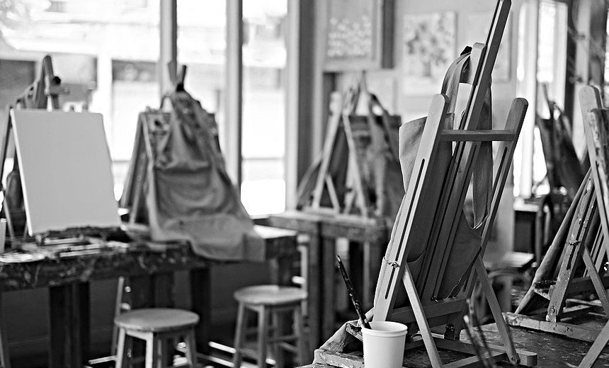 Interior of the creative art workshop with wooden easels and painting equipment